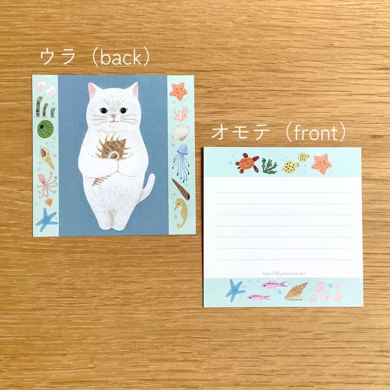 4legs Cat Memo - New #3 Shiro-Neko
Featuring charming watercolor of a cat holding a shell from Japanese illustrator 4legs
It is a convenient size that is not too big or too small. Please use it as a communication tool for small thank you and announcements. There are no lines on the front side, so you can use it freely as a shop card or business card with stamps and stickers as well as memos and letters. It is a great gift for people who like paper. The gorgeous