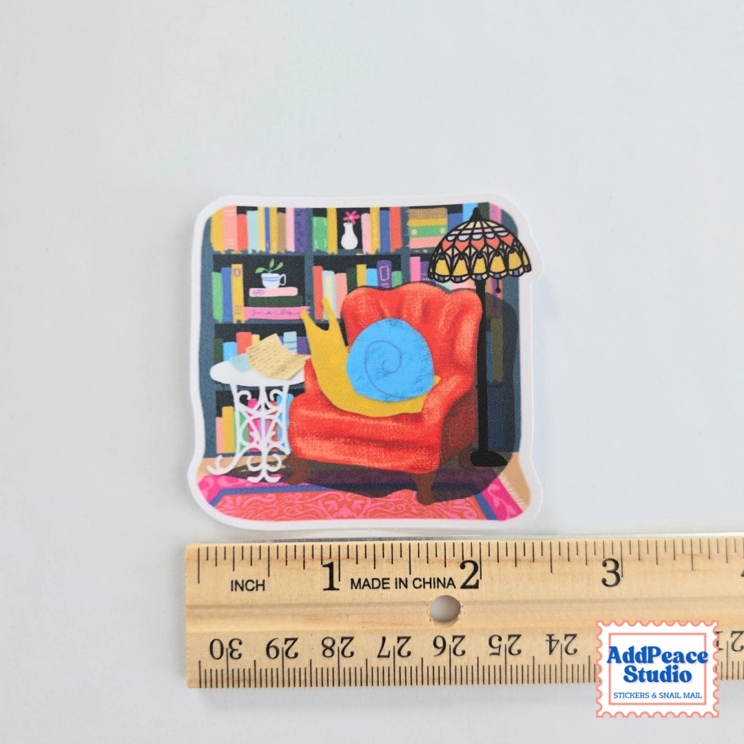 AddPeace Studio - Reading Snail Vinyl Sticker
This illustrated sticker features a snail settled into a wingback chair, surrounded by shelves of books and warm lamplight, completely lost in a letter. It captures that quiet, immersive feeling of disappearing into the analog world and not wanting to come back.
Details:
Size: 2.5"
Material: Waterproof, scratch-resistant matte vinyl
Made in USA, original artwork by AddPeace Studio