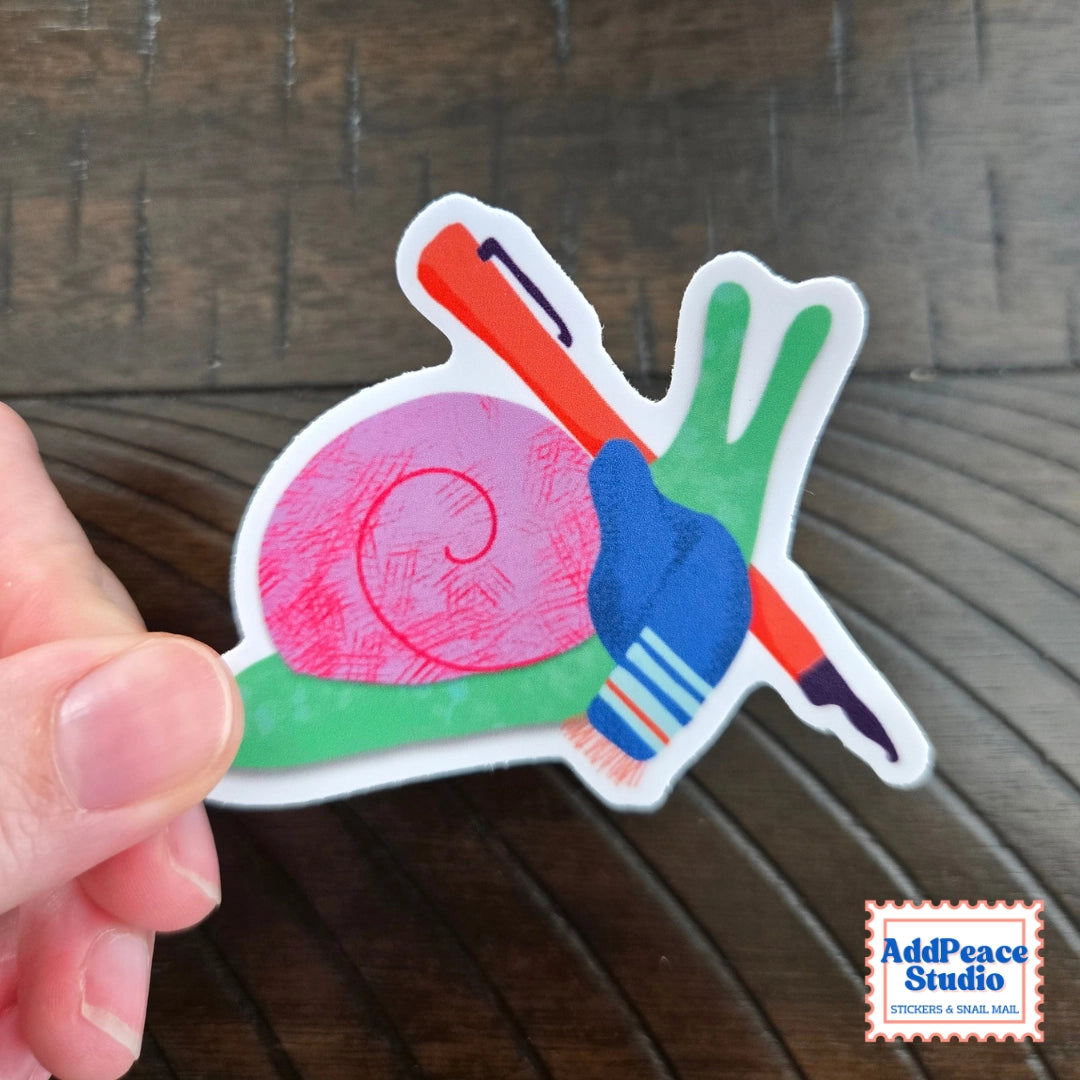 AddPeace Studio - Writing Snail Vinyl Sticker
This illustrated sticker features a snail wrapped in a scarf and holding a fountain pen, fully in its element. Thoughtful, creative, and a little poetic, it’s made for anyone who feels at home with pen in hand and ideas waiting to be written.
Details:
Size: 2.5"
Material: Waterproof, scratch-resistant matte vinyl
Made in USA, original artwork by AddPeace Studio