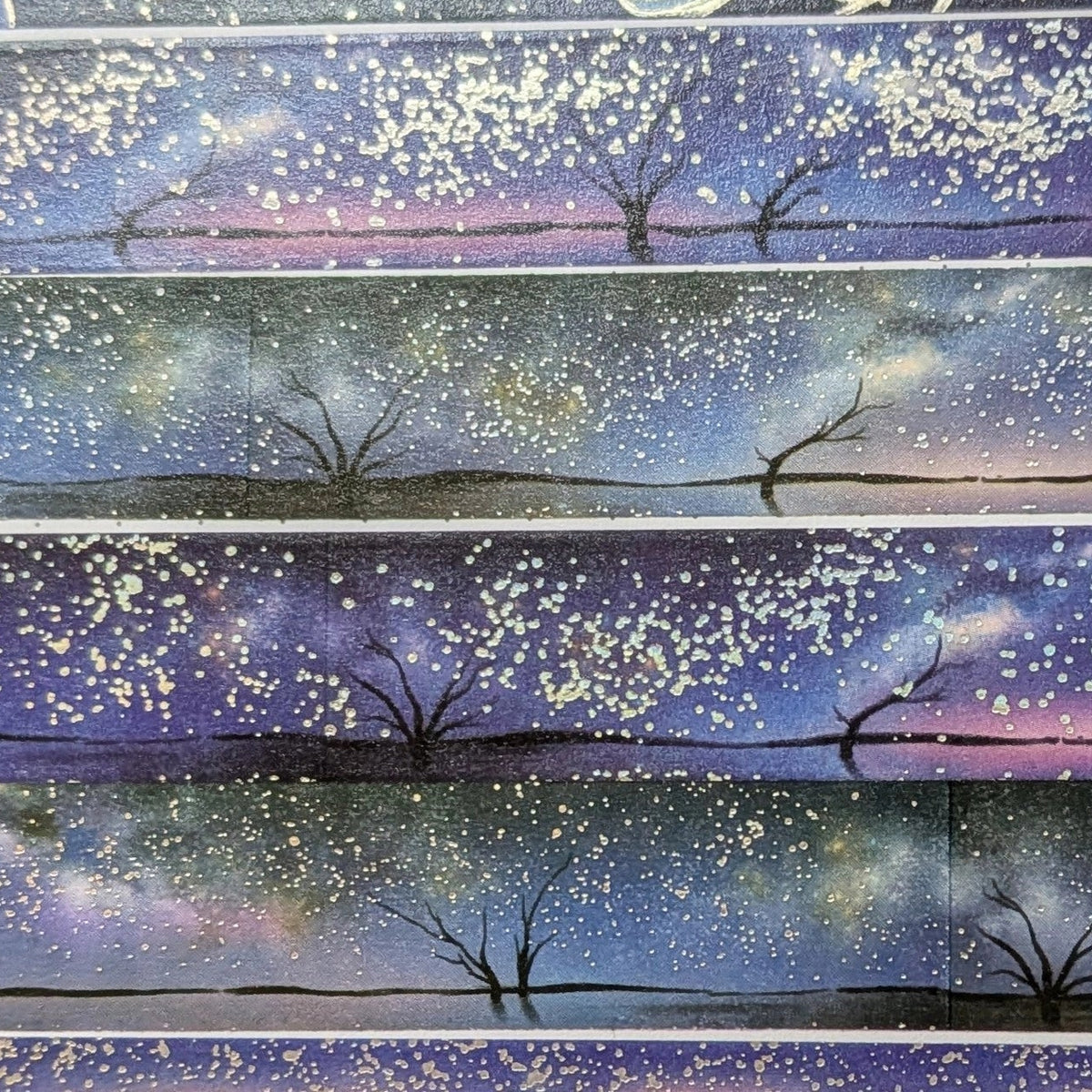 AdrianSlothArt - Holographic Foil Galaxy Washi Tape
Dreamy washi tape with holographic foil stars featuring a landscape with the milky way, tree silhouettes, and water reflections.
Details:
15 mm x 10 m
holographic foil washi tape
There are 2 versions of this design. This listing is for the more saturated version. The second version is more desaturated and has slightly darker colors.