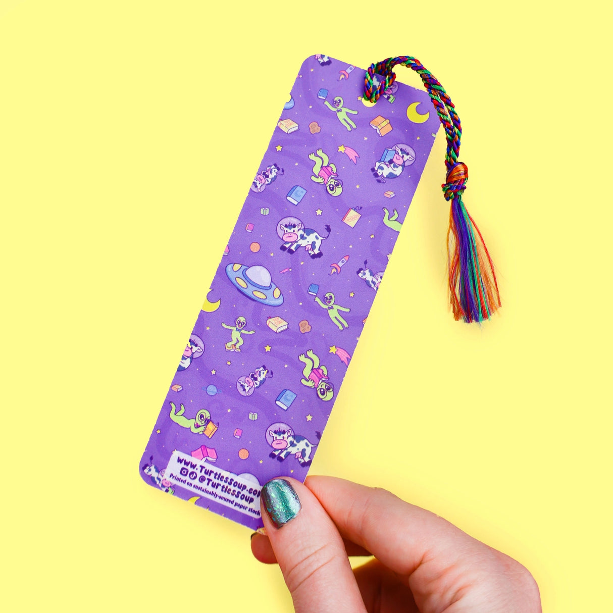 'Alien Abduction Bookmark by Turtle's Soup. Libraries beware! This nerdy alien is abducting every book in town! He loves reading the unique stories that fill planet Earth. His abduction beam has a wide range, so he might accidentally pick up some life forms as well. Hopefully, they don’t mind reading among the stars with him!
Hold your spot in style with our fun and funky bookmark collection! Whether you prefer romance, fantasy, or science fiction, our bookmarks will fit perfectly between the pages of your