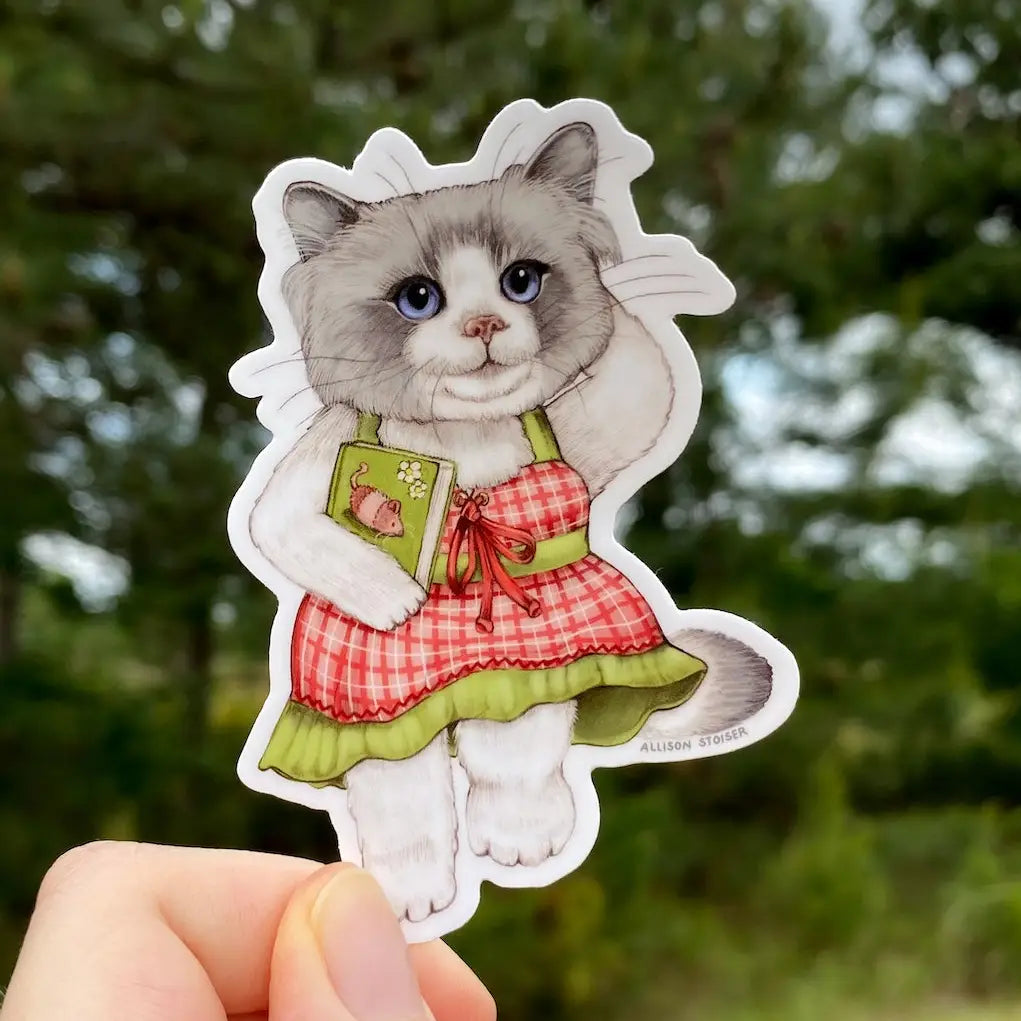 Allison Stoiser Art - Beach Read Bookish Ragdoll Cat Vinyl Sticker
What's better than a day at the beach and the perfect beach read? Absolutely nothing, according to this beach-going ragdoll cat.