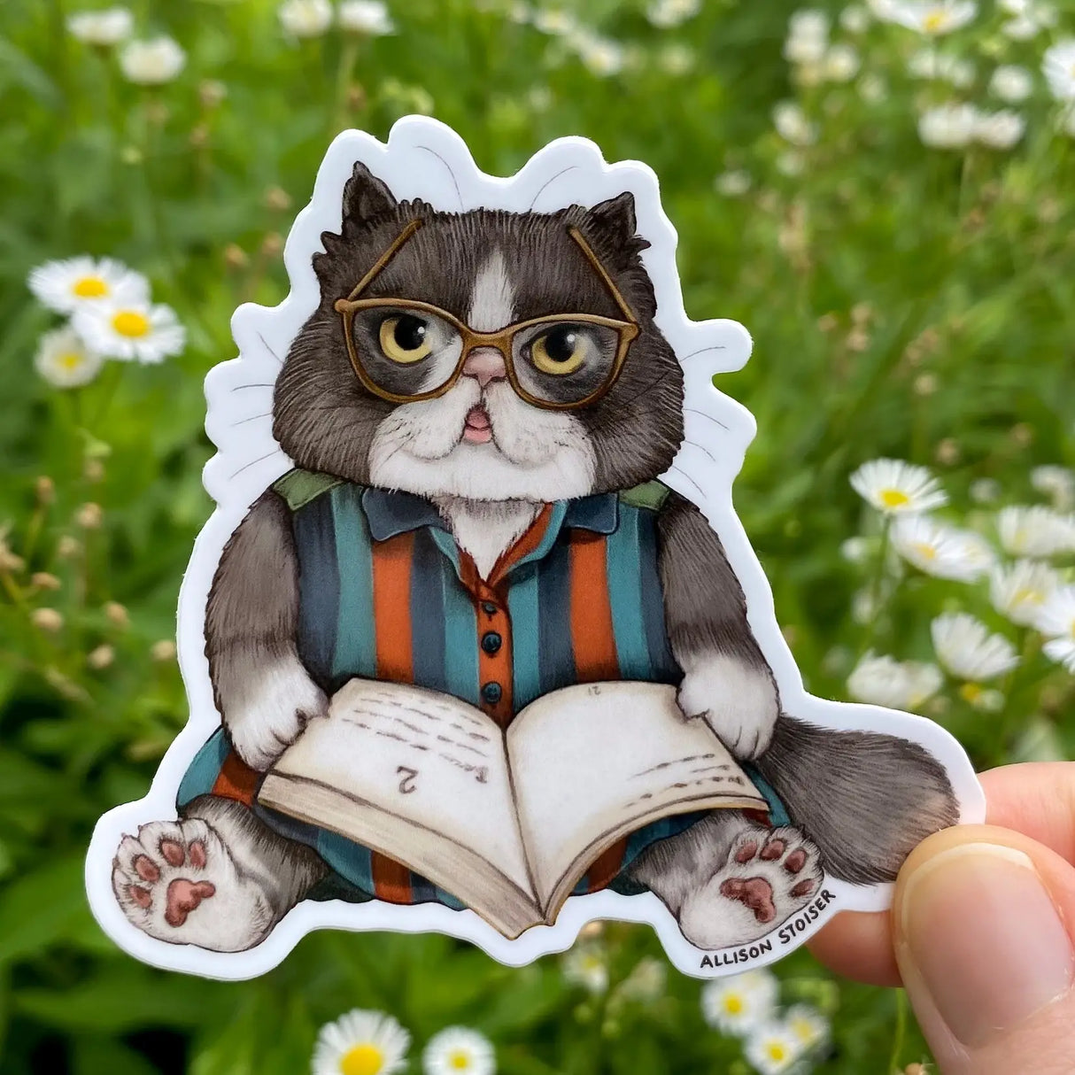 This Persian cat is settled in with a hefty tome—perhaps Purrsuastion or A Tale of Two Kitties.
This 3" die-cut gloss vinyl sticker is durable, weatherproof, and perfect for water bottles, notebooks, laptops, bikes, and all sorts of other surfaces! Make sure to clean and dry the surface thoroughly before applying.