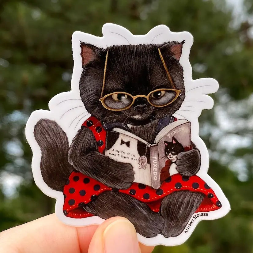 A mystery at the movies? This little black cat can't wait to see how Tuxedo, the famed feline detective, cracks this case!
This 2.5" die-cut gloss vinyl sticker is durable, weatherproof, and perfect for water bottles, notebooks, laptops, bikes, and all sorts of other surfaces! Make sure to clean and dry the surface thoroughly before applying.