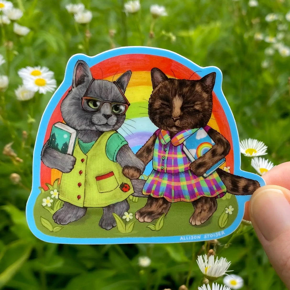 Allison Stoiser Art - Rainbow Gal Pals Bookish Cats Vinyl Sticker
Nothing to see here! Just a couple of gals being pals and going on a reading date at the park. This Russian blue cat and her tortoiseshell cat companion can't wait to sit under a shady tree and read the books they just picked out at their favorite bookstore!