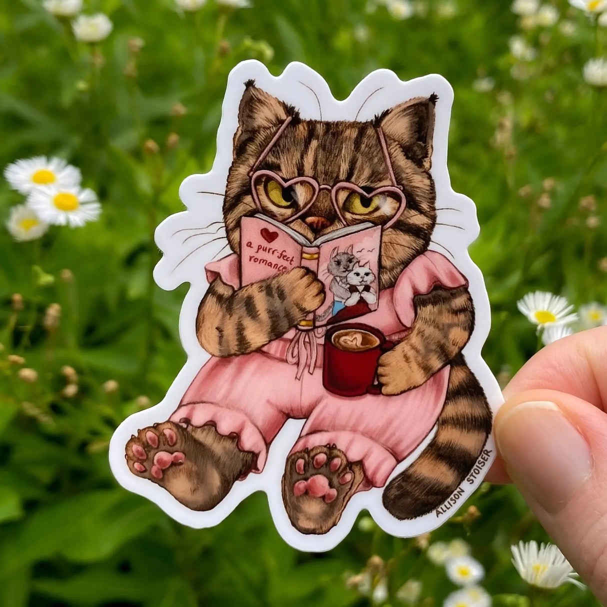 Allison Stoiser Art - Romance-Loving Bookish Tabby Cat Vinyl Sticker
What's better than cozying up with your favorite toasty beverage and the purr-fect romance novel? Absolutely nothing, according to this tabby cat!