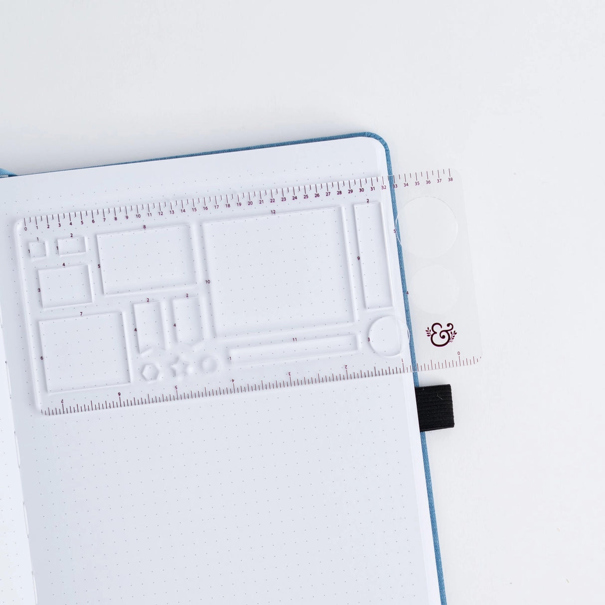 Get precise and achieve perfect outlines in your journal with our A5 Dot Grid Planning Stencil. This handy grid spacing guide helps you measure out your bullet journal spreads with ease. Simply pick a layout and use the dot grid journal ruler to mark out each box.
The stencil features half square notches, guide boxes, helpful shapes, and more so you can quickly create an entire journaling spread without the worry of counting dots or having uneven lines!
This stencil is particularly helpful for A5 notebook