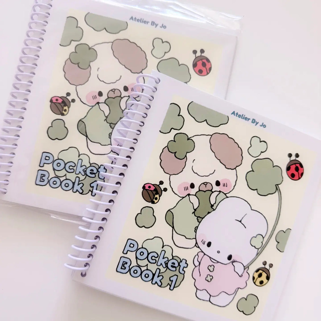 Cozy Creativity Anywhere with the Atelier by Jo Pocket Coloring Book! ✨
Bring Cotton and Pluto along on your everyday adventures with this adorable Pocket Coloring Book featuring simple and cozy Atelier by Jo character pages! Filled with 20 original illustrations in a compact 4 x 5 inch format, this spiral-bound mini coloring book is designed for relaxing, stress-free coloring anytime and anywhere.
Featuring sweet character moments, cute everyday scenes, and easy-to-color designs, this collection is perfe