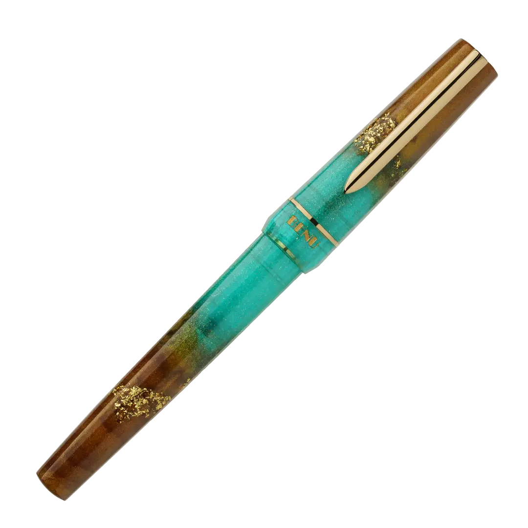BENU presents the newest Haute Collection — a line of elegant, fashion-inspired pens that blend classic charm with bold, modern flair. The designs include both subtle and vibrant styles, showcasing BENU’s signature glitter and color artistry. Each pen features a faceted body with alternating wide and slender facets, complemented by either gold-plated or chrome-plated trims for a sleek, timeless look.
Seal and caramel tones swirl together, flecked with radiant gold. Lush evokes runway opulence — bold, textu