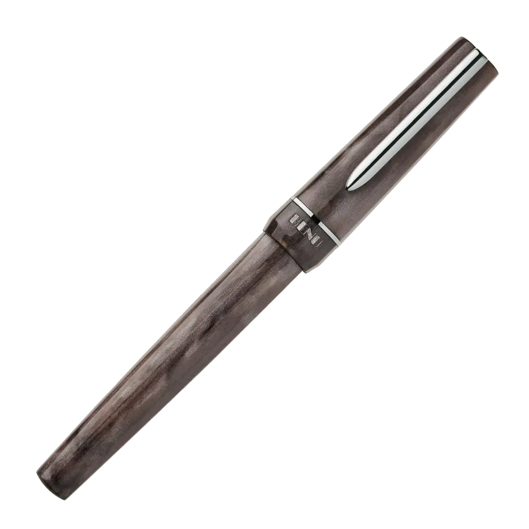 BENU presents the newest Haute Collection — a line of elegant, fashion-inspired pens that blend classic charm with bold, modern flair. The designs include both subtle and vibrant styles, showcasing BENU’s signature glitter and color artistry. Each pen features a faceted body with alternating wide and slender facets, complemented by either gold-plated or chrome-plated trims for a sleek, timeless look.
With smoky gray marbling and polished chrome hardware, Satin is the essence of modern elegance. Understated