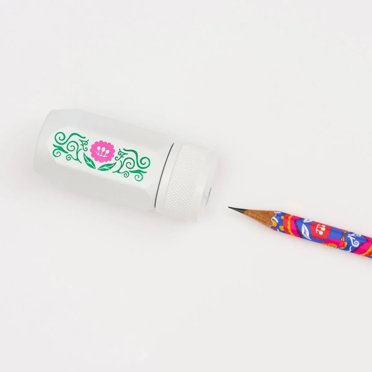 Volume 143 is our tribute to Frida Kahlo. The model number 143 is a nod to the 143 paintings commonly attributed to her over the course of her life.
This limited-edition Volume 143 Blackwing Long Point One-Step Sharpener comes in white with a Frida Kahlo-inspired floral design on the side. The sharpener body is made of durable, machined aluminum, and the sharpening unit features a premium German steel blade for consistent pencil sharpening. The canister can hold three fresh pencil sharpenings before needin