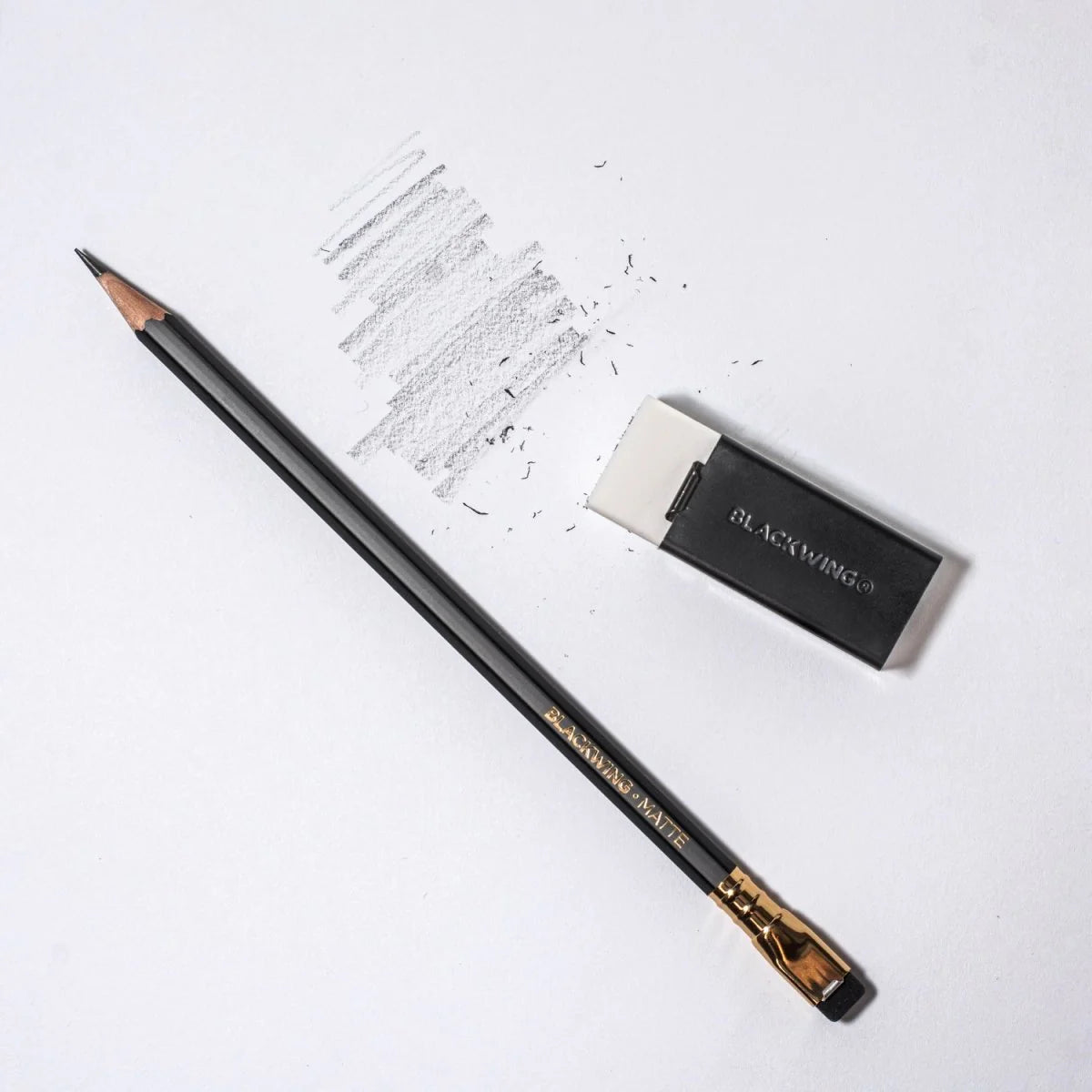 We took the iconic design of our eraser clip and adapted it into a sleek handheld form that feels great to use.
The eraser is made of a special soft material that erases the dark lines of our graphite cleanly and easily. The holder is made of durable aluminum that lets you get a solid grip while erasing. It also includes a jumbo-sized version of the iconic Blackwing clip, so you can extend the eraser as you use it.