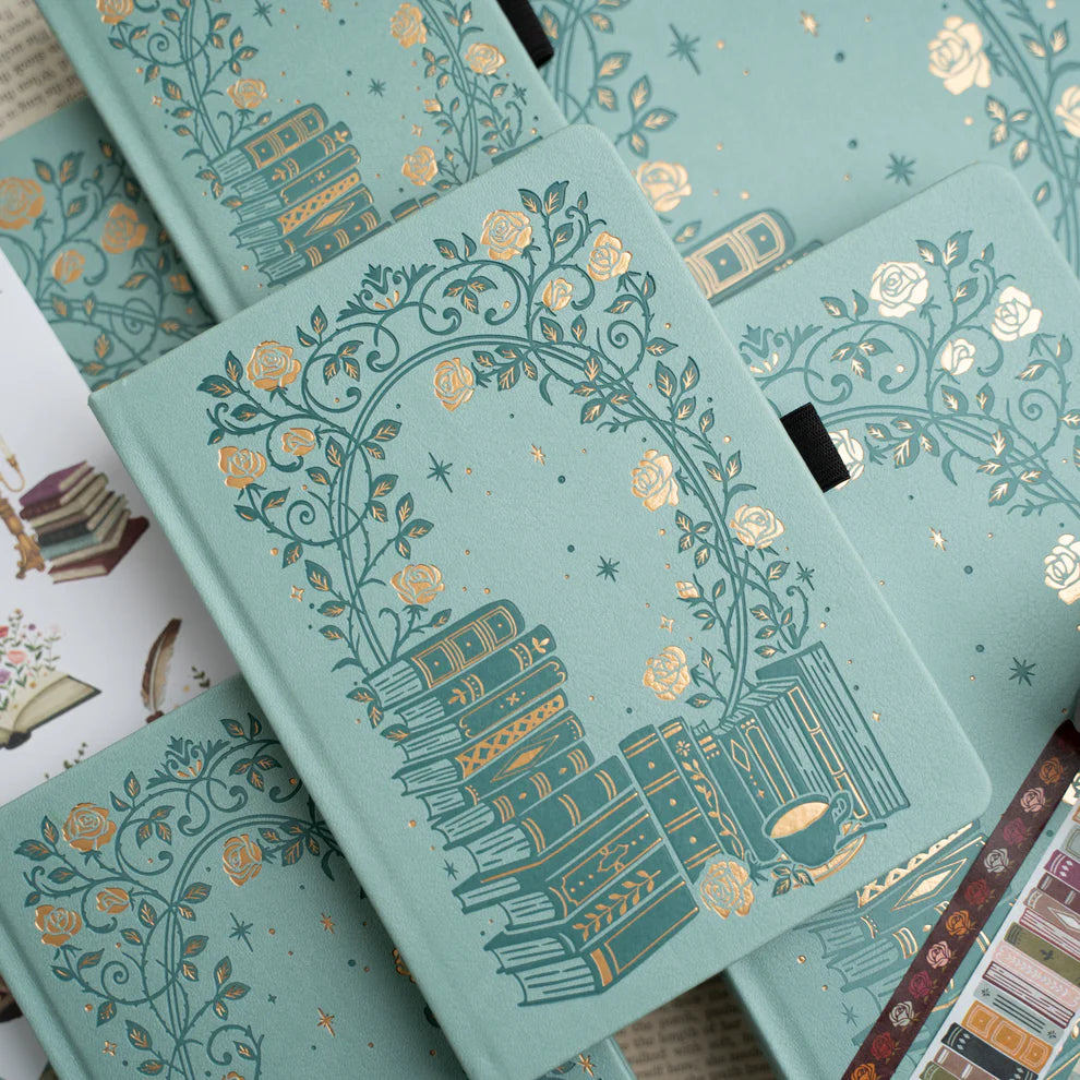 A love letter to book lovers, the Books of Beauty Reading Notebook is designed for cozy reading moments and thoughtful reflection.
Featuring a soft vegan leather cover in a dreamy seafoam hue, delicate gold-foil accents, and an elegant interior end page pattern, this notebook is as beautiful as it is functional—perfect for reading logs, book reviews, TBR lists, and journaling your favorite quotes.
A timeless addition to any stationery or bookish collection—ideal for readers, writers, and journal lovers.