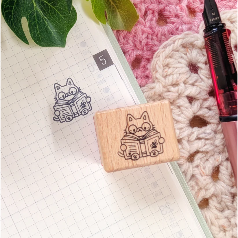 A small wood stamp of a little literary kitty for your planner and scrapbooking needs. Each stamp measures approximately 1 x 0.75 inch.
Stamps come loose and without any extra packaging.