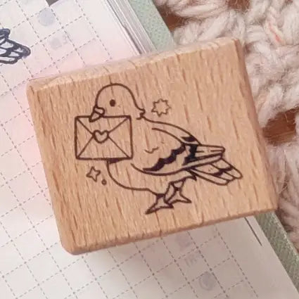 A small wood stamp of a little pigeon delivering your mail for your planner and scrapbooking needs. Each stamp measures approximately 1 x 0.75 inch.
Stamps come loose and without any extra packaging.