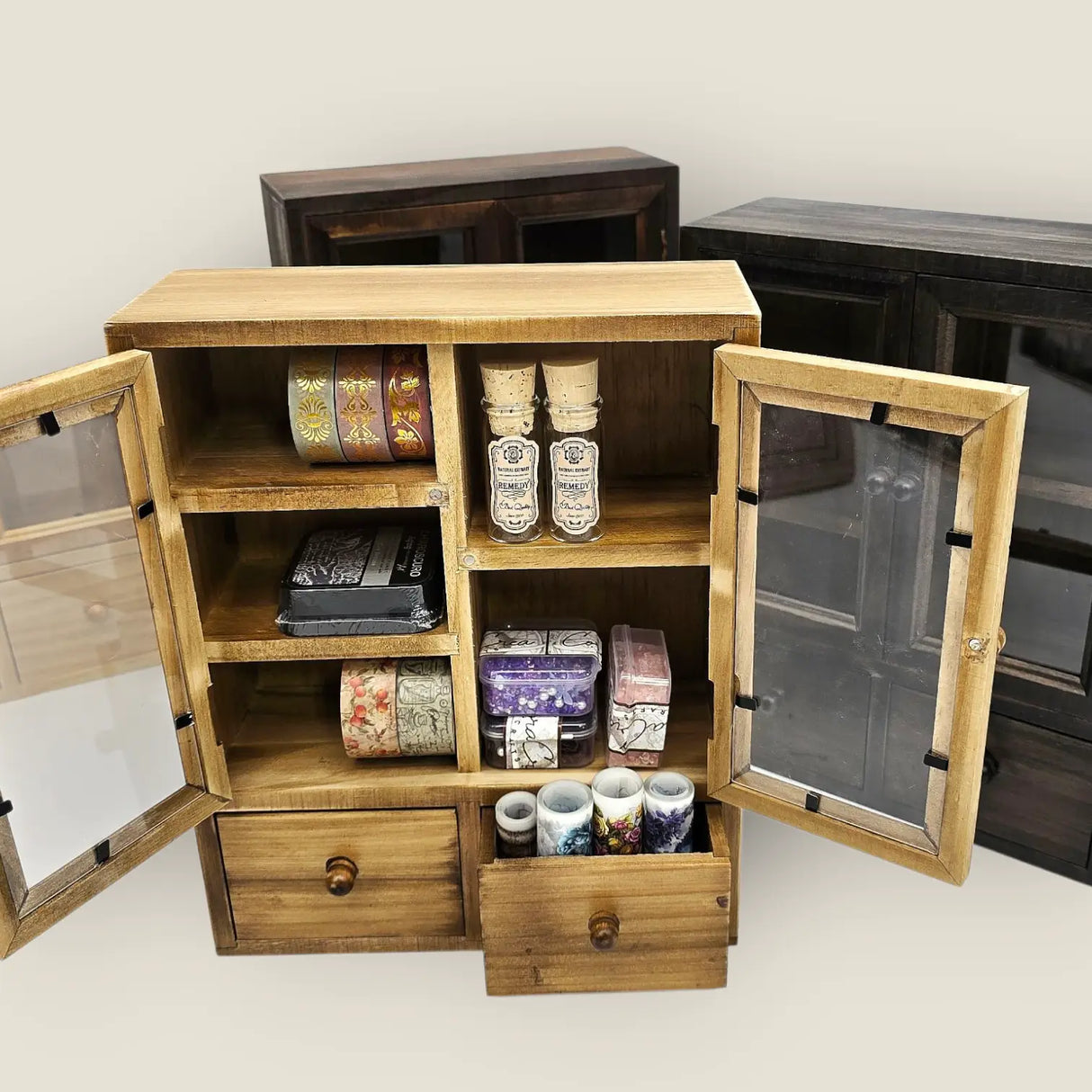These wooden cabinets will add a beautiful decorative touch to your desk or creative space. They are also highly functional, with two drawers, and shelves of different heights. This product is handmade and an exclusive design of CoraCreaCrafts.
Important Note: This product includes the wooden cabinet only. Any decorative items on the inside are for display purposes only.
Size: 20 x 25 x 7.5cm