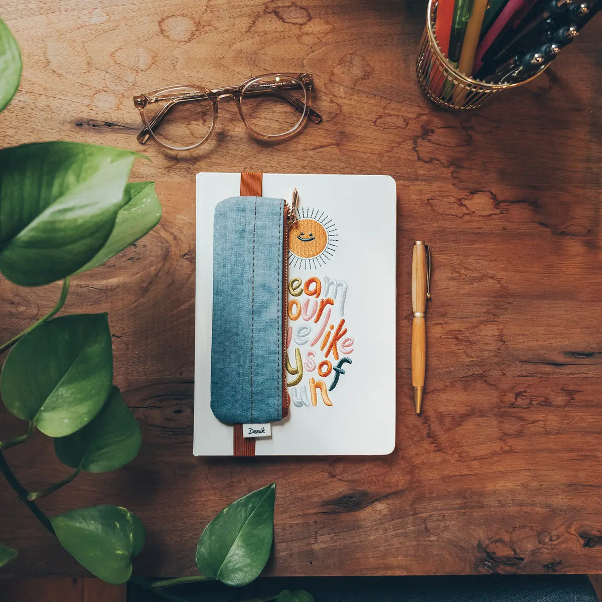 Denim Distressed Blue Notebook Pouch
Keep your go-to notebook and must-have pens together with our Denim Blue Notebook Pouch (honestly, we should’ve made these sooner). Designed with a fabric front, PU back, and a fully nylon-lined interior, it features an elastic band that fits snugly around most notebooks—so you’re ready for everyday ideas on the go.
Vegan Leather Pouch with Zipper
Elastic Fits Books up to 9" High
Zipper closure
9" x 3.75"