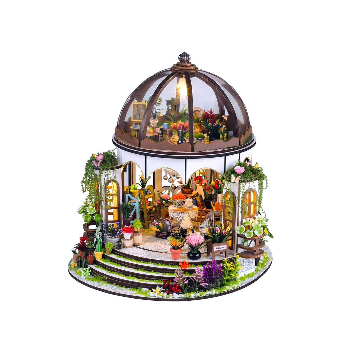 Step into a tranquil garden escape with this miniature kit-a sun-drenched sanctuary filled with flourishing plants, rustic charm, and peaceful vibes. This beautifully crafted greenhouse-style gazebo features delicate woodwork, glass-like panels, and an inviting open-air design surrounded by vibrant flowers, climbing vines, and cozy garden furniture. Whether you're dreaming of a relaxing afternoon under the sun or a quiet place to sip tea and tend to your plants, this miniature brings that dream to life-one