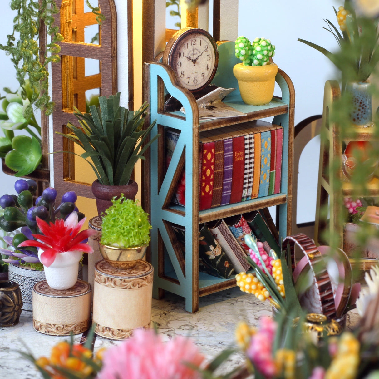 Step into a tranquil garden escape with this miniature kit-a sun-drenched sanctuary filled with flourishing plants, rustic charm, and peaceful vibes. This beautifully crafted greenhouse-style gazebo features delicate woodwork, glass-like panels, and an inviting open-air design surrounded by vibrant flowers, climbing vines, and cozy garden furniture. Whether you're dreaming of a relaxing afternoon under the sun or a quiet place to sip tea and tend to your plants, this miniature brings that dream to life-one