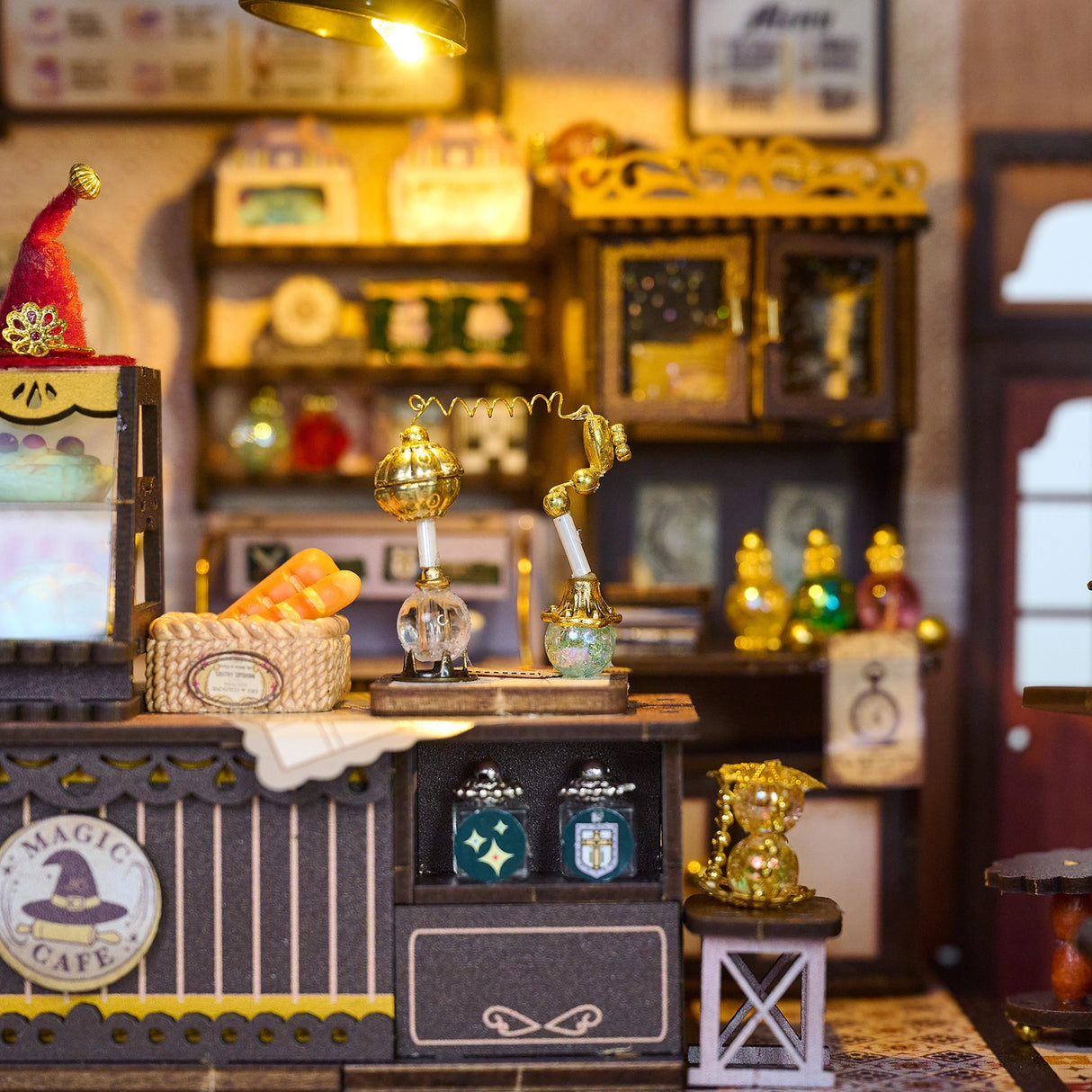 Step into a whimsical world of sugar, spells, and stardust with the Magic Café DIY Miniature House Kit. This enchanting build-it-yourself café brings to life a cozy little corner where witches, wizards, and woodland creatures gather for enchanted brews and magically infused pastries. Watch as tiny shelves fill with jars of mysterious ingredients, and the glass display case glows with cakes that sparkle with edible enchantments.
2 AAA batteries required; batteries are not included.
Ages 14+ 380 pieces
Assem