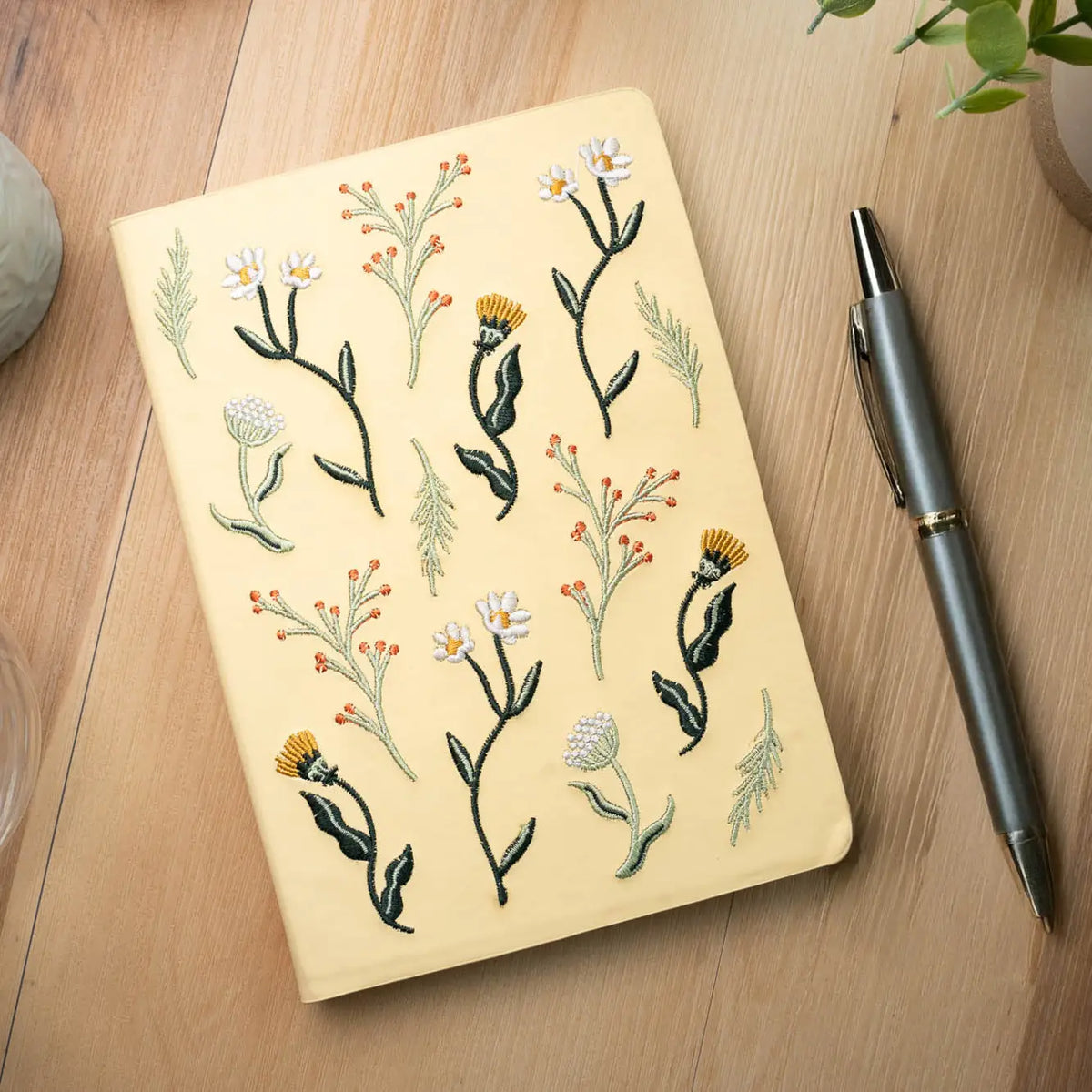 Embroidered Butter Yellow Blooms Hardbound Notebook
Premium embroidered cover and beautiful cream-colored lined pages making it easy to keep track of even the smallest details. Complete with a rich, satin ribbon allowing you to bookmark your favorite pages and experiences.
5.75" x 8.25" hardcover journal notebook
Embroidered cover artwork
144 lined pages
Glorious Smythe-sewn binding allows notebook to lay flat
Ribbon Bookmark
Durable binding and high-quality paper for a premium writing experience
Ideal fo