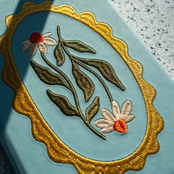 Embroidered Daisy Frame Hardbound Notebook
A premium hardcover notebook featuring precision embroidery on a vegan leather cover. Designed for everyday use, it includes smooth-lined pages, a Smythe-sewn layflat binding for effortless writing, and a satin ribbon to mark your place.
New inside page design
Soft Touch Embroidered Hardcover
5.75" x 8.25"
144 Lined Pages
Contrast Endpages
Satin Ribbon Bookmark & Pen Loop