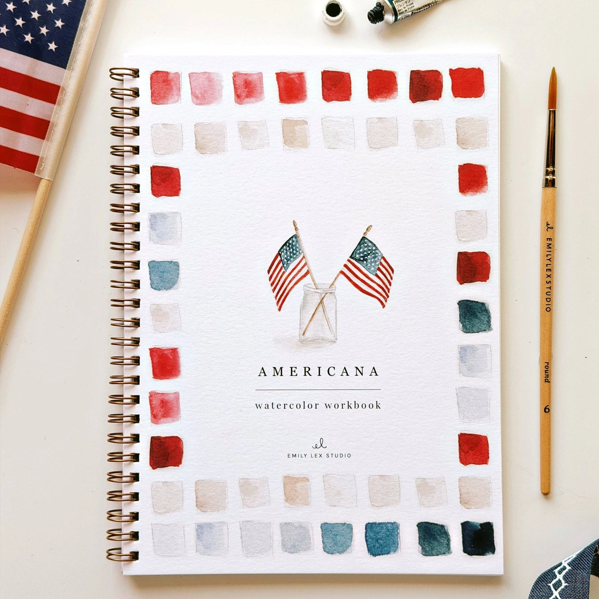 Twelve illustrations of flags, stars, and classic summer scenes — each pre-outlined with step-by-step instructions. Paintings take about thirty minutes from start to finish, making it approachable for first-time painters and a favorite for gifting.
A timely release for America's 250th anniversary in 2026. A strong May–July seller and a natural fit for home, gift, and patriotic-themed boutiques.
12 beginner-friendly illustrations
Thick 120lb watercolor paper
Lay-flat pages with spiral binding for has