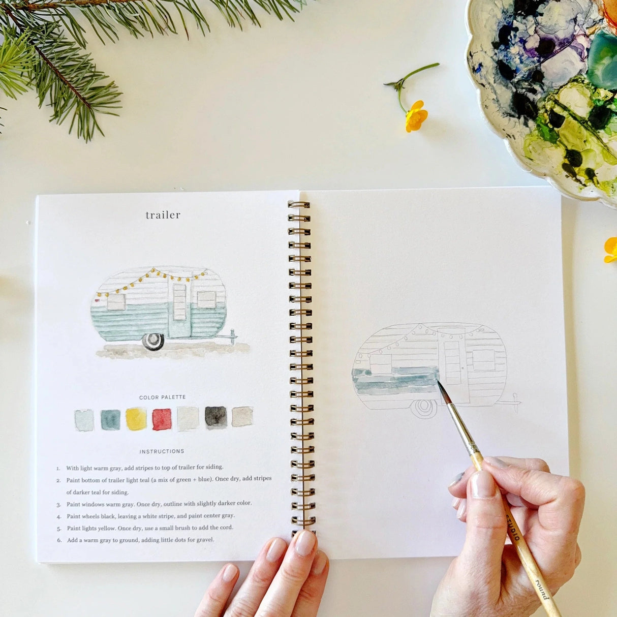 Twelve camping illustrations — a vintage camper, lantern, campfire, tent, canoe, s'mores, and more — each pre-outlined with step-by-step instructions. Paintings take about thirty minutes from start to finish, making it approachable for first-time painters and a favorite for gifting.