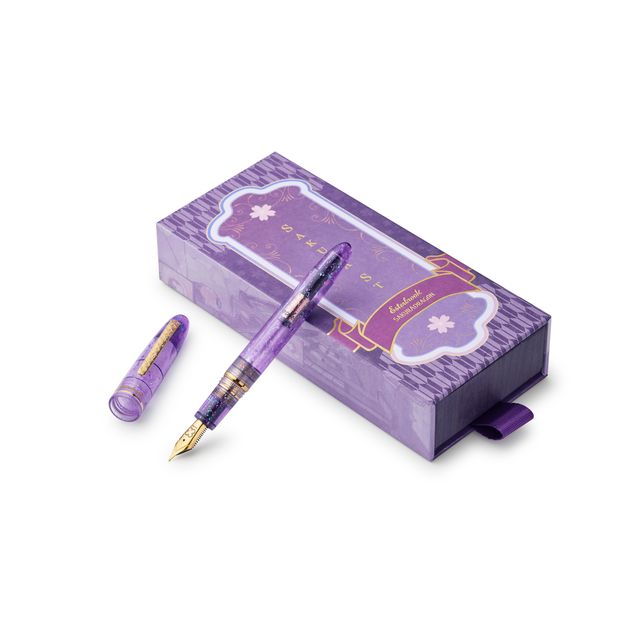 Esterbrook x Sakuradragon Sakura Street Estie Fountain Pen
Created with artist Cindy Duong of Sakuradragon, the Sakura Street Estie brings her imaginative illustrated world to Esterbrook's traditional Estie fountain pen. Its U.S.-blended material combines translucent purple with colorful glitter sparkle, while the custom clip is etched with Cindy's Sakura pattern. Dual Esterbrook and Sakuradragon engraving and a gold-plated converter finish the design. Each pen arrives in special packaging with Japanese gi
