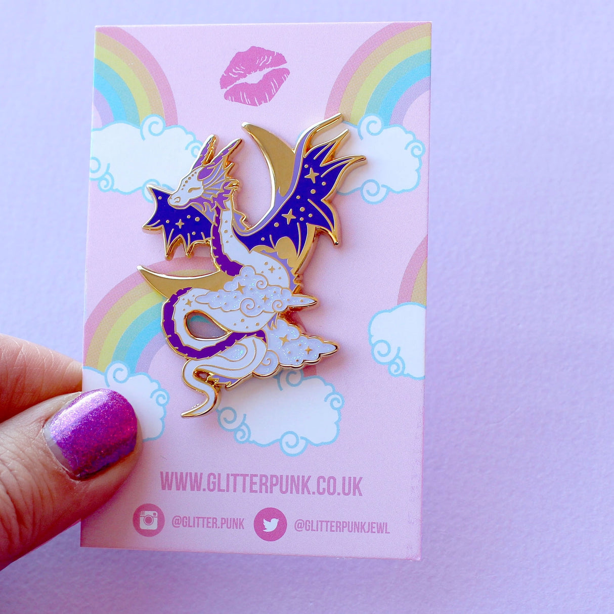 Glitter Punk - Celestial Dragon Enamel Pin
This fabulous starry Celestial Dragon pin is perfect for fans of the mythical!
Made from gold hard enamel, this 48mm purple dragon is surrounded with glittery clouds and a large gold crescent moon. It is secured with two purple heart rubber clasps.
