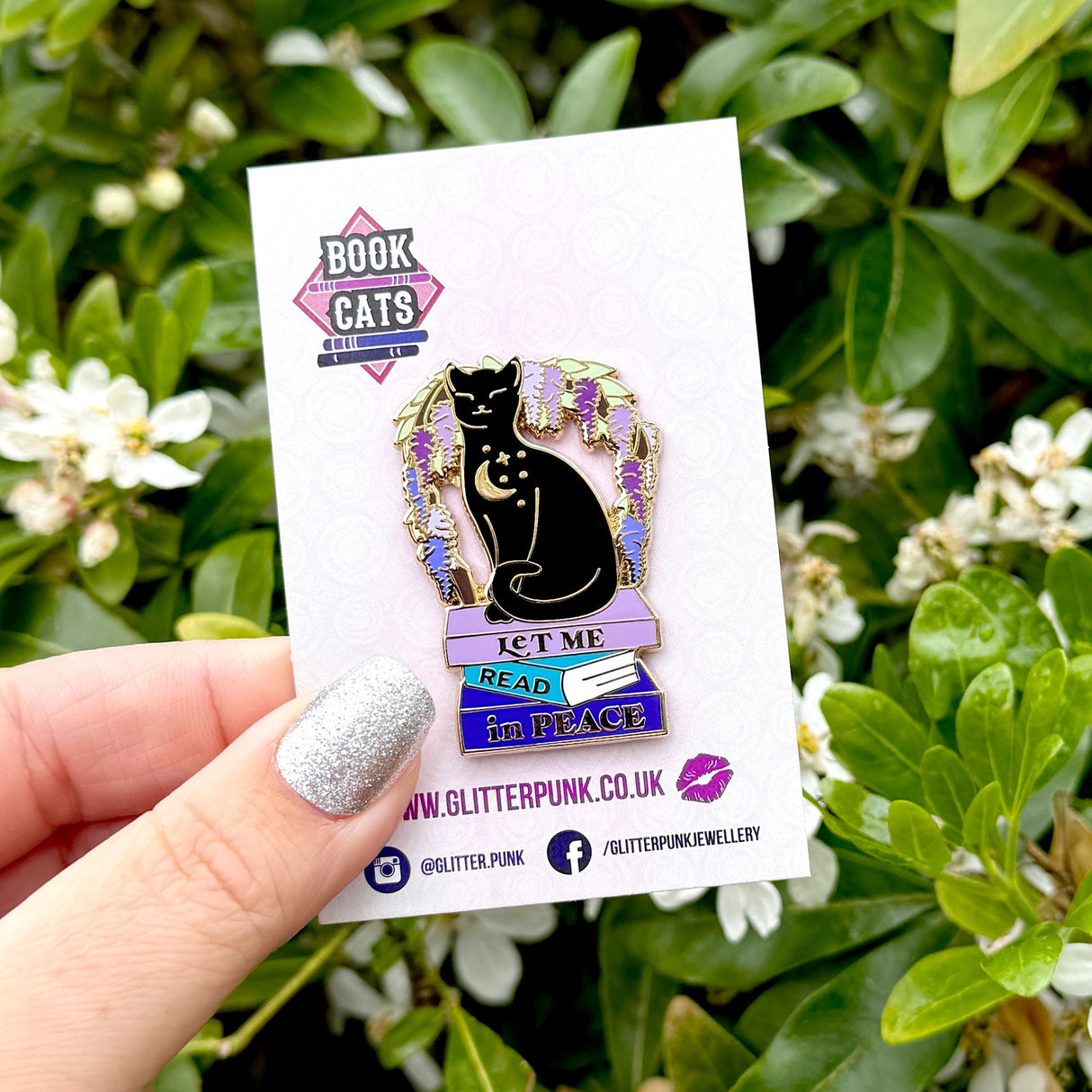 We’ve all had moments where we wish the world would just leave us alone so we can get lost in a good book! This gorgeous enamel pin features a black cat underneath an arch of wisteria, sitting on a pile of books with the slogan ‘Let me Read in Peace’
Measurements: 44mm (1.73”)