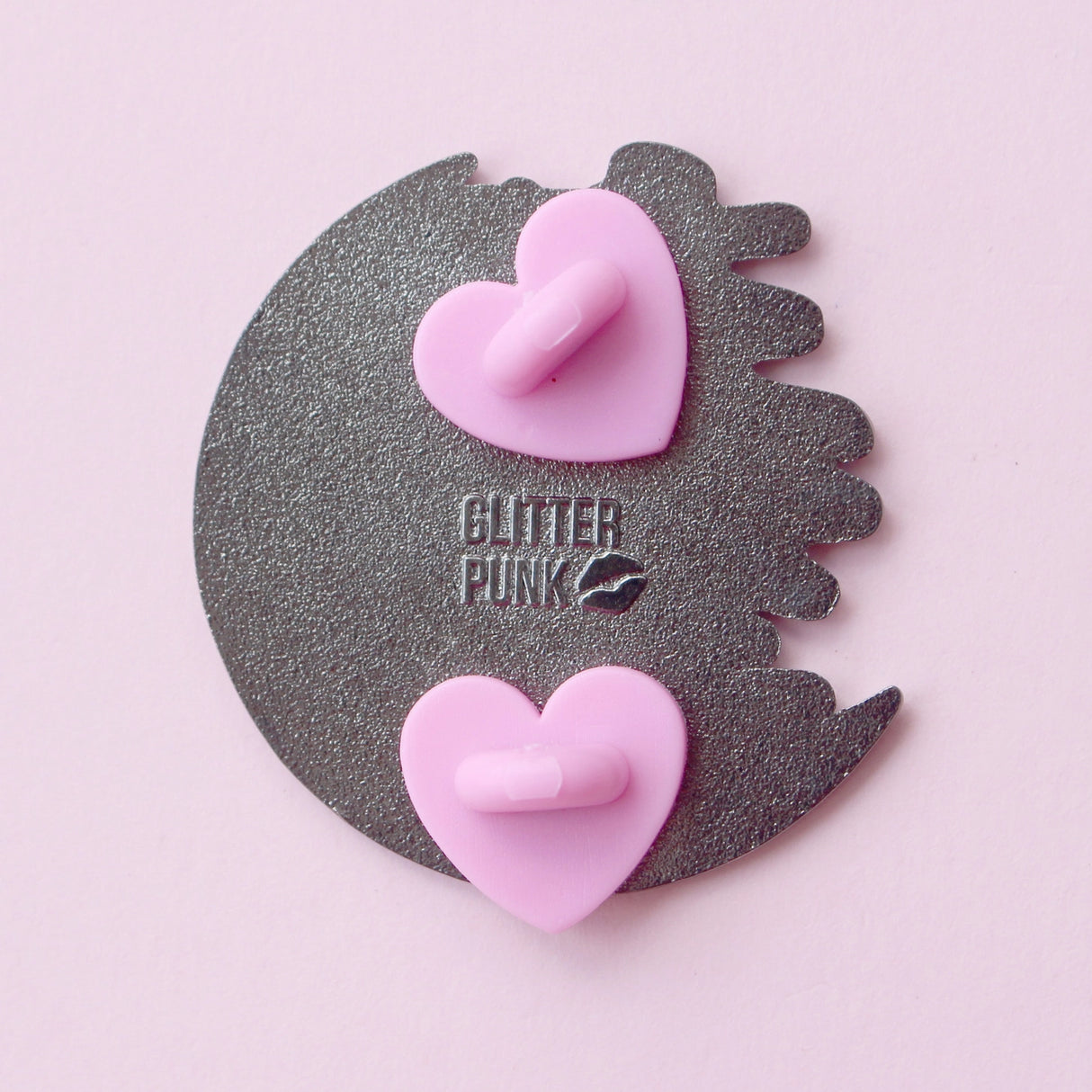 Calling all owners of a long haired pointed / meezer cats! This super cute design features the cat sitting in front of a sparkly moon with a glittery, starry sky in the background.
The pin is 40mm (1.57”) tall, and is made from gunmetal hard enamel, with glitter and UV printed details. It's secured with 2 pink clutches to keep the pin in place.