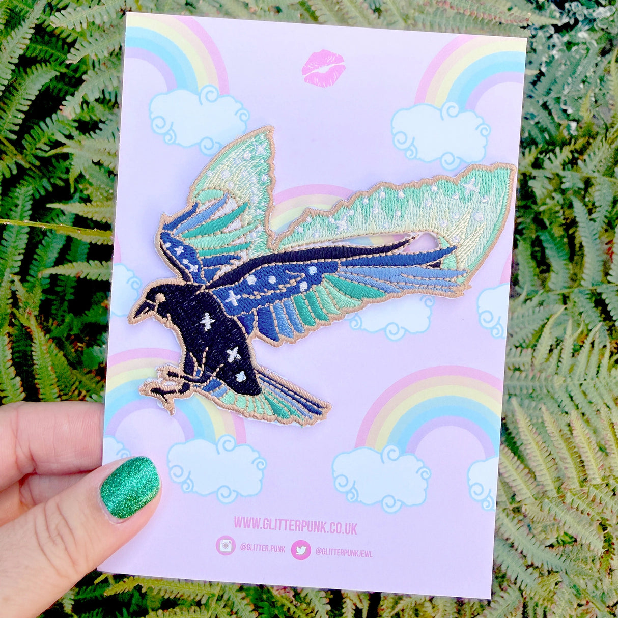 This amazing patch features a raven with its wings outstretched and the northern lights fanning out behind it.
Beautifully woven with black, green, blue & gold threads, this fabulous patch with brighten up any coat, bag or hat!
Measurements: 85 x 87mm