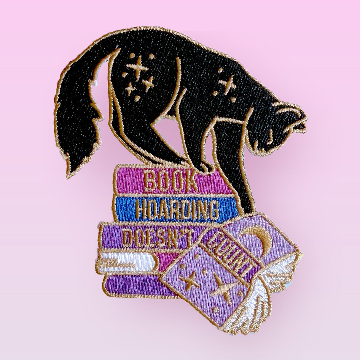 Everybody loves a neat and tidy space, but those groaning book shelves definitely don’t count as a problem! This fab patch is perfect for book lovers – either as a little treat for yourself, or a gift for the bookworm in your life.
Beautifully woven with black, purple, blue and gold threads, this fabulous patch with brighten up any coat, bag or hat!
Measurements: 75mm x 90mm