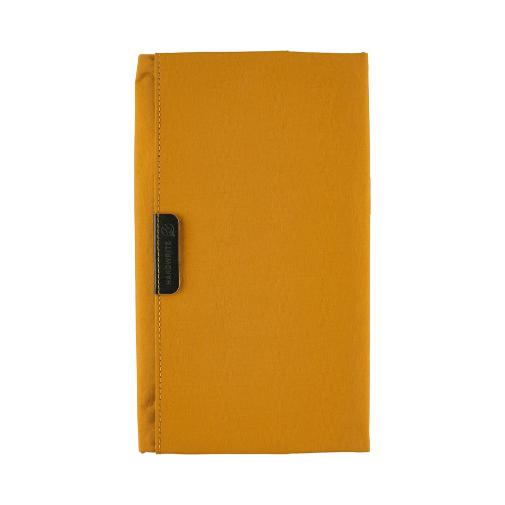 Its standout feature is the generously sized pocket, but its overall appearance remains clean and minimal. The vibrant yet subdued mustard color gives it a beautiful finish that suits anyone, regardless of style. Though it folds into thirds and fastens with a magnetic closure, the cover is light in hand. The aim was effortless elegance, something that looks sharp without being flashy. The material is a soft nylon with a sophisticated sheen.