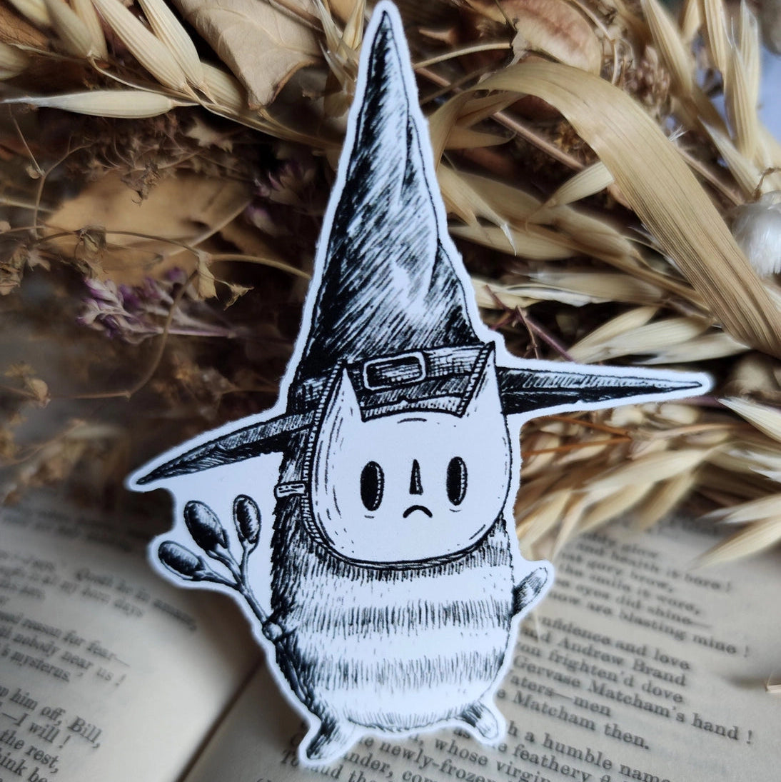 Sticker featuring a tiny wizard spirit in a big hat, from my original pen and ink artwork.
Die-cut vinyl sticker, suitable for interior or exterior use. Available as a single sticker or a set of five matching stickers to share with friends. Measures approximately 8.5cm (3.3 inches) at its tallest point. 