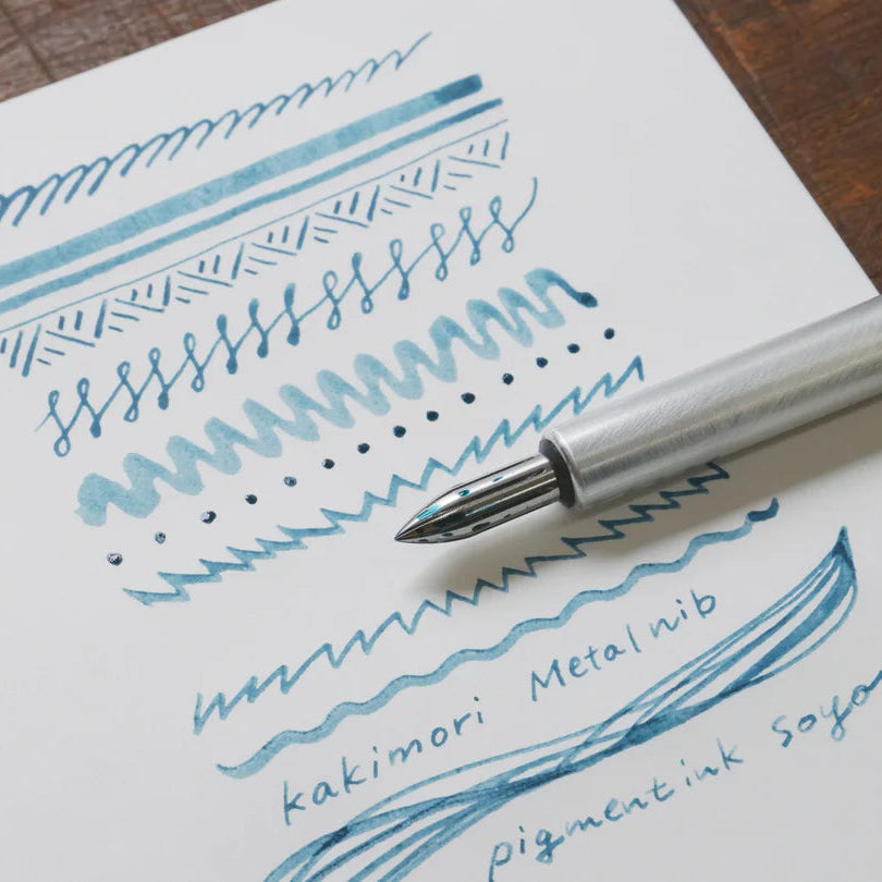 The stainless steel nib was born from a desire for a durable and practical dip pen nib. Enjoy a variety of line widths from fine to broad by tilting the nib at different angles. Fits most nib holders as well as those from our range.
The nib was designed by Yuto Yamazaki of Kuramae-based design studio Alloy. The nib tip has been rounded and polished with meticulous care, providing a remarkably smooth writing experience that defies expectation. Perfected over many iterations, the innovative nib is like no ot
