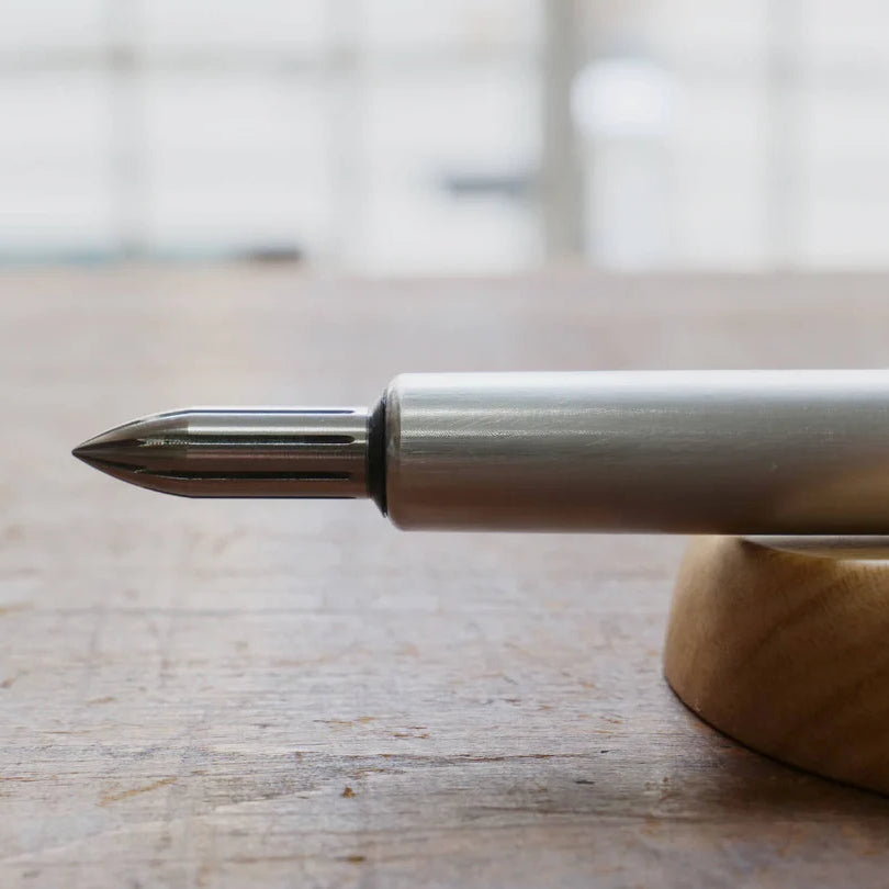 The stainless steel nib was born from a desire for a durable and practical dip pen nib. Enjoy a variety of line widths from fine to broad by tilting the nib at different angles. Fits most nib holders as well as those from our range.
The nib was designed by Yuto Yamazaki of Kuramae-based design studio Alloy. The nib tip has been rounded and polished with meticulous care, providing a remarkably smooth writing experience that defies expectation. Perfected over many iterations, the innovative nib is like no ot