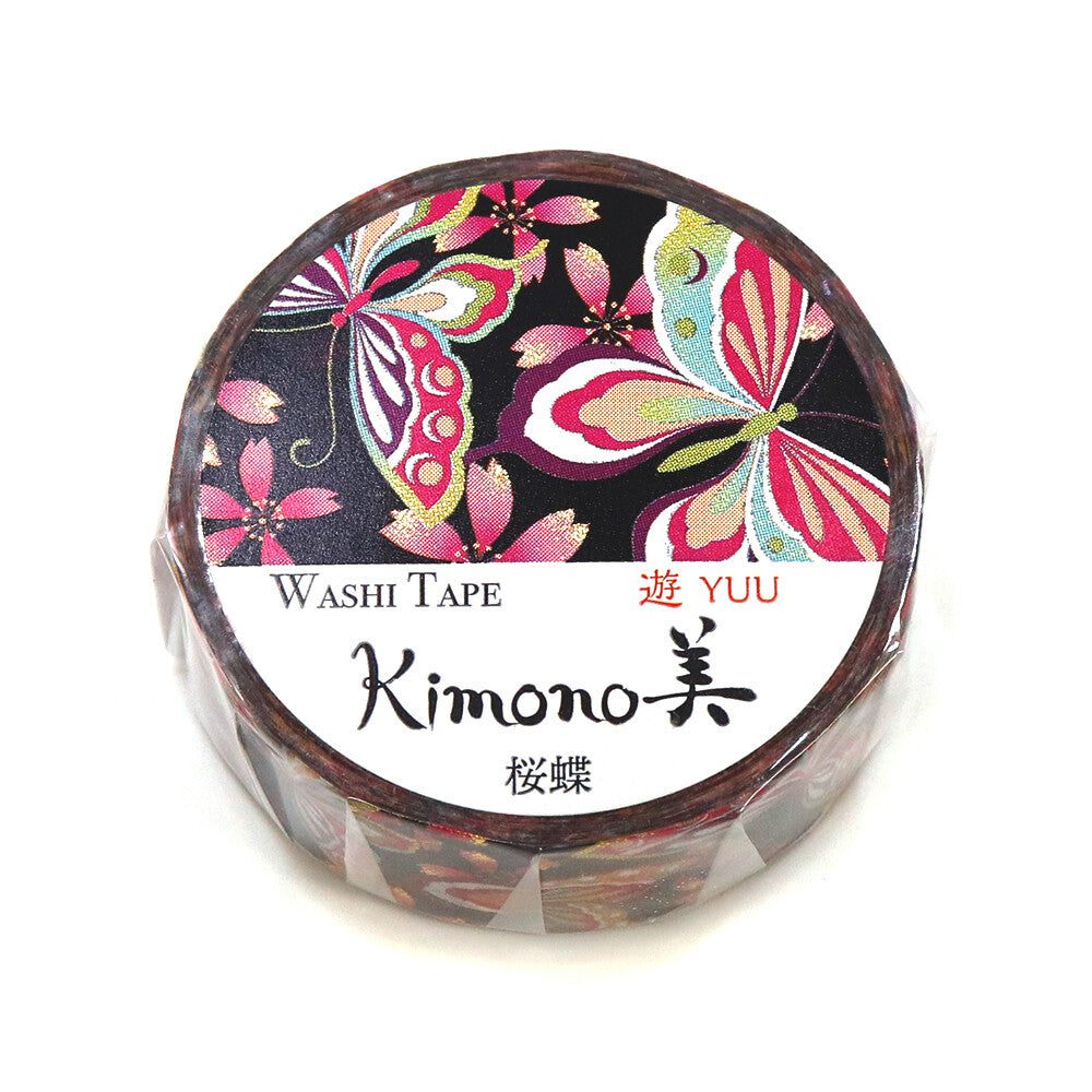 A roll of decorative washi tape with a black background and colorful butterfly and floral patterns, wrapped in clear plastic with a white label reading 'WASHI TAPE Kimono美' and 'YUU'.