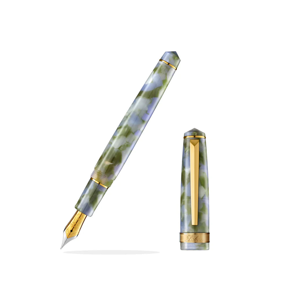 The Laban Rosa collection offers a fresh, modern look with its compact size and vivid colors. Lightweight and well-balanced, it’s the perfect choice for first-time fountain pen users. Fitted with a smooth steel nib and gold-plated trim, the Rosa brings style and ease to everyday writing.
Fresh and Fearless Spring: Lilac
Lilacs always bloom for Easter, and after Easter, the daytime gets longer. We see hope for tomorrow through the flourishing spring; it is a fresh and fearless season.
Light bluish-purple