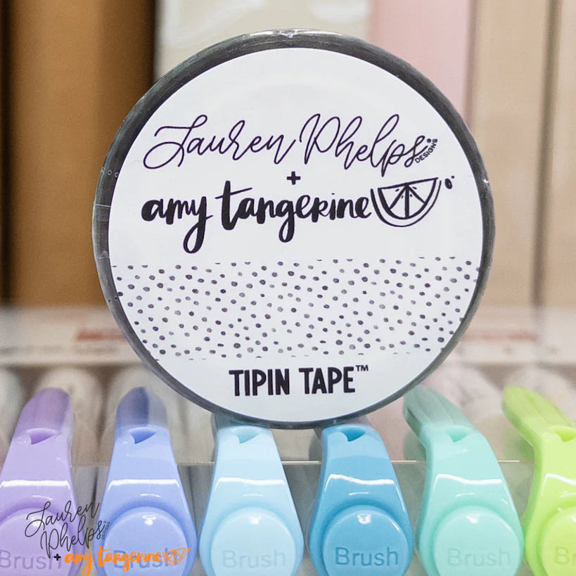 Do you love adding interactive elements to your scrapbook layouts like photos, journaling cards, patterned paper, ephemera, and keepsakes, but want a clean, professional way to attach them without bulky adhesives or visible hinges?
Tip In Tape™ was designed for exactly that.
Tip In Tape™ is a clear matte PET tape created for adding interactive elements to scrapbook pages and paper crafting projects with precision and ease. It allows you to create flip-ups, tip-ins, layered details, and movable elements wh