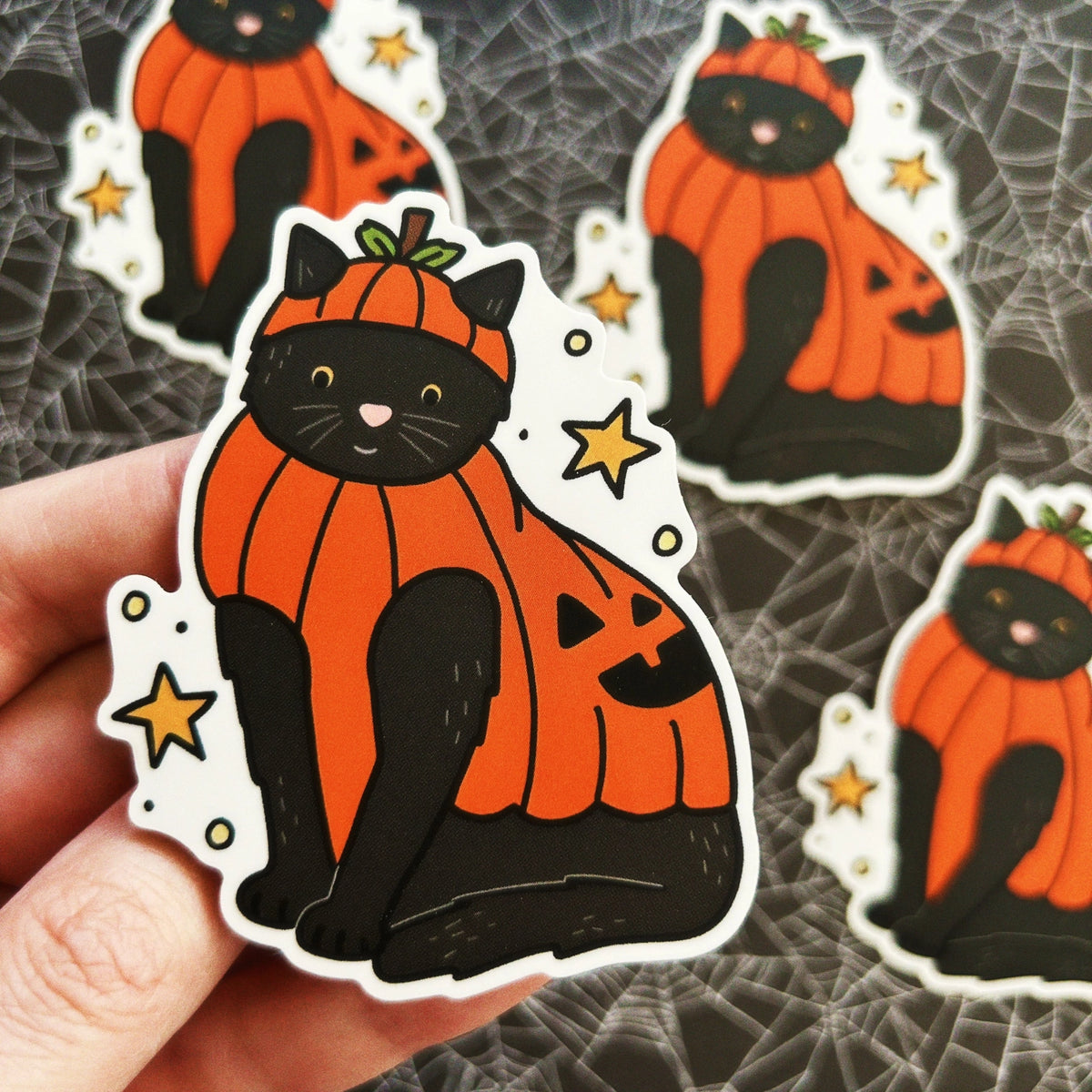 Little Spooky Studio - Beanie Pumpkin Cat Vinyl Sticker
A black cat wearing a pumpkin costume :)