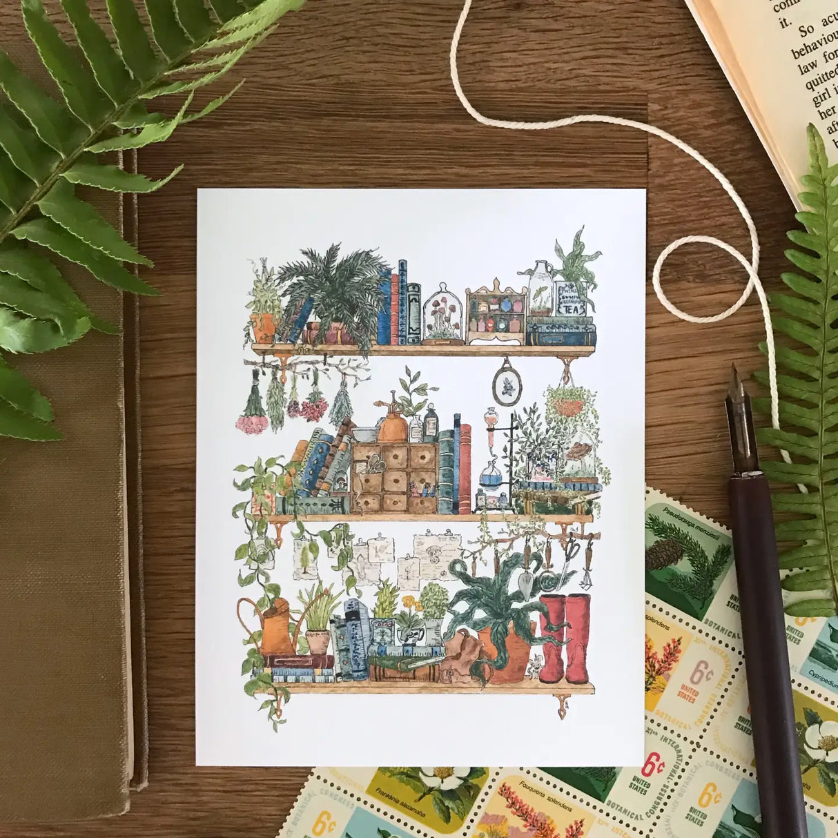 Lizzy Gass Postcard - The Botanist's Shelves
Postcard featuring my original watercolor and ink illustration of the vintage oddities and books tucked away in the shelves of a botanist, including lots of mushrooms, a tiny mouse, and red rain boots for traipsing through forests and fields to collect samples.
• Printed and cut in my studio on high quality, matte card using archival ink
• Each postcard measures 4.25 x 5.5" (A2)