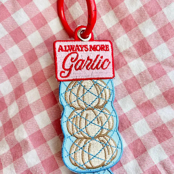 These cute embroidered keychains attach with a colorful ring clasp and are perfect for attaching to your keys or bag to bring with you on all of your adventures!
A recipe asks for 2 cloves of garlic? You mean two bulbs? The recipe is WRONG! There should always be MORE garlic. This is the perfect item or gift for foodies, chefs and cooking enthusiasts, and lovers of all things garlicky.
Includes one keychain only.
Embroidered on both sides.
Materials: Cotton, Polyester, Brass