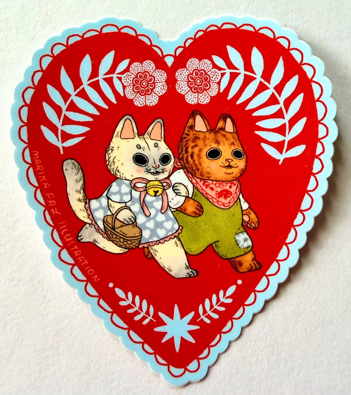 Two cats go for a walk on this folk art inspired sticker.
This vinyl matte sticker is weather and waterproof-stick it on a notebook, bike, or car- it's going to stick around! Heck, throw it on a water bottle and through the dishwasher. This sticker can go anywhere. Sticker measures 3.5" x 4.5" Printed in USA.