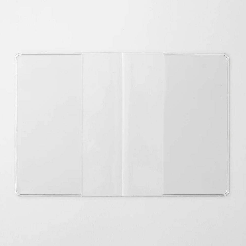 A transparent cover that fits snugly around your MD Notebook
This is a special cover that gently wraps your MD Notebook. The transparent cover protects the notebook from dirt without ruining its appearance.
It subtly protects your notebook from water and dirt without interfering with its characteristics. If you put the cover on with the glassine paper still wrapped around it, the inorganic feel of the vinyl will be softened.
Because it is transparent, you can enjoy the cover design, illustrations, and writ