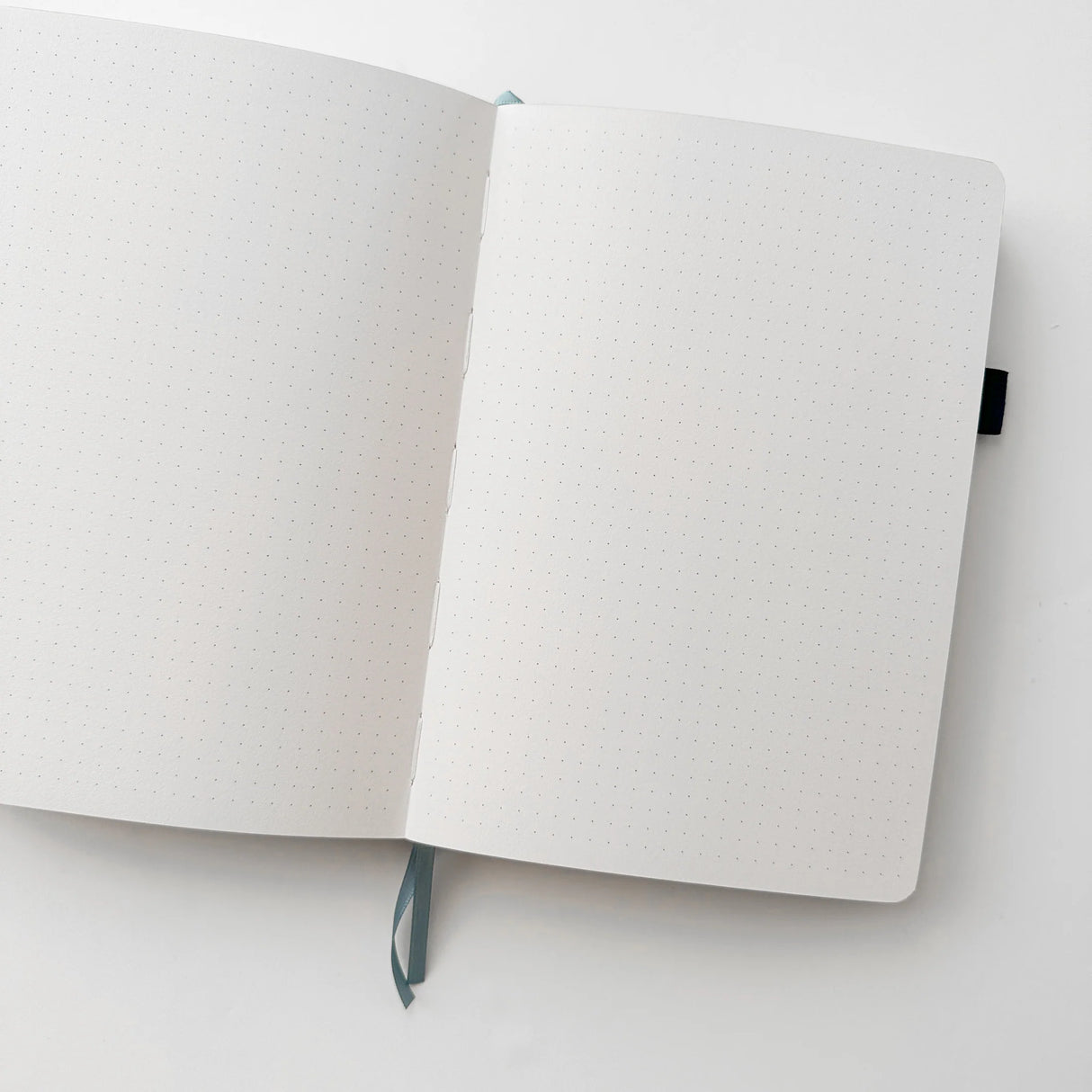 Jiji The Cat Journal in Ocean Blue with Holographic Edges and Logo 🌊✨
Product Details:
Size: A5 (5.70 x 8.26 inches)
160 Dotted Grid Pages (5 x 5 mm)
2 Bookmarks
Elastic Band and Pen Holder
Expandable storage compartment