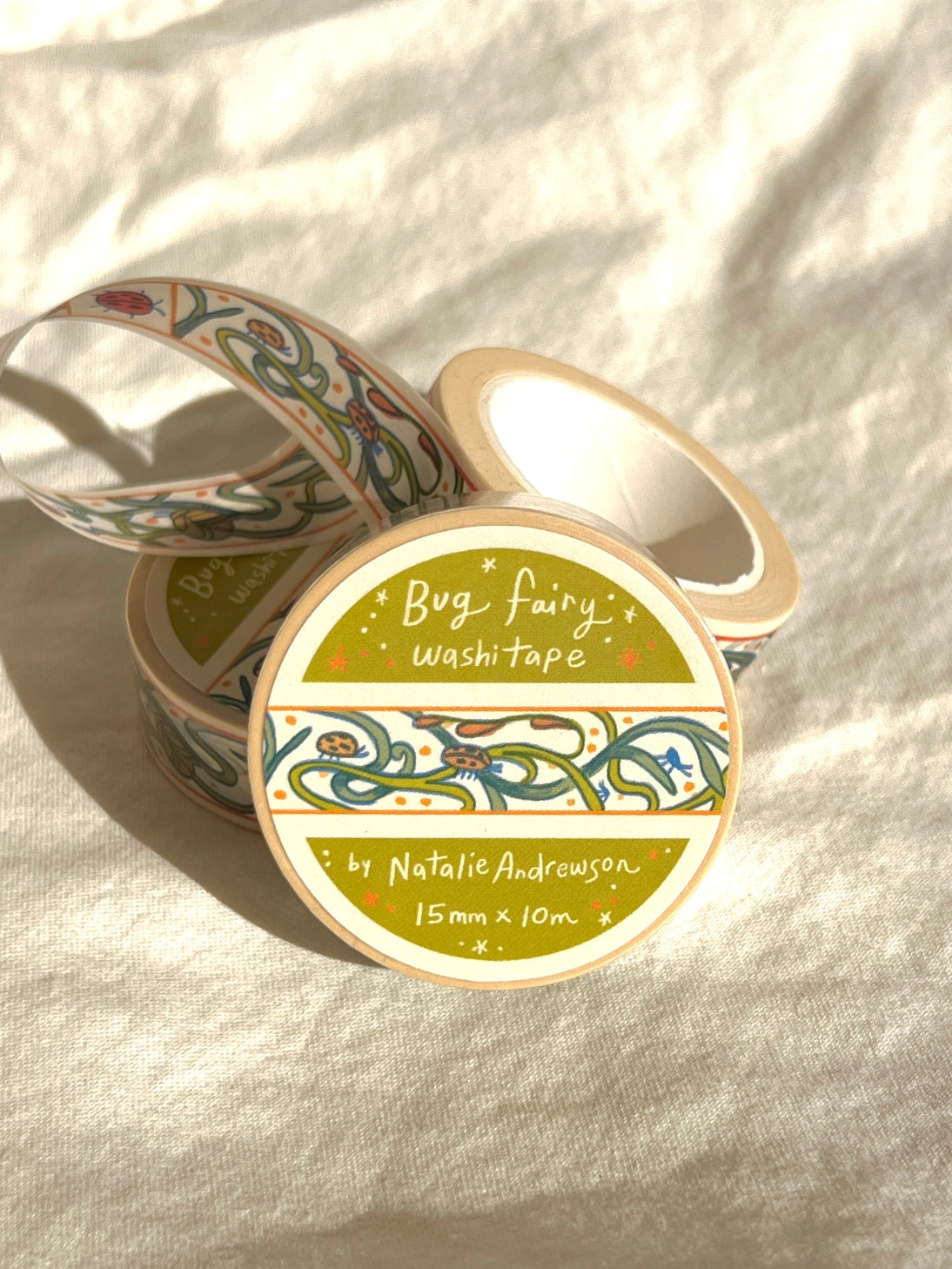 This washi tape features little bugs hidden in vines! Taken from the borders of my Bug Fairy print.
This roll is 15mm wide x 10m of paper tape. Washi tape is super durable and flexible. It tears easily and can be safely applied to a variety of surfaces; it doesn’t leave a sticky residue behind, making it especially ideal for stationery and hanging prints temporarily.