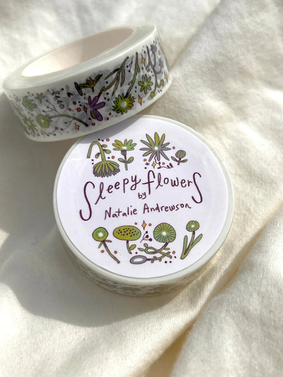 This washi tape features fluid green and purple flowers dancing loosely around to create an energetic, yet soft tape.
This roll is 15mm wide x 10m of paper tape. Washi tape is super durable and flexible. It tears easily and can be safely applied to a variety of surfaces; it doesn’t leave a sticky residue behind, making it especially ideal for stationery and hanging prints temporarily.
