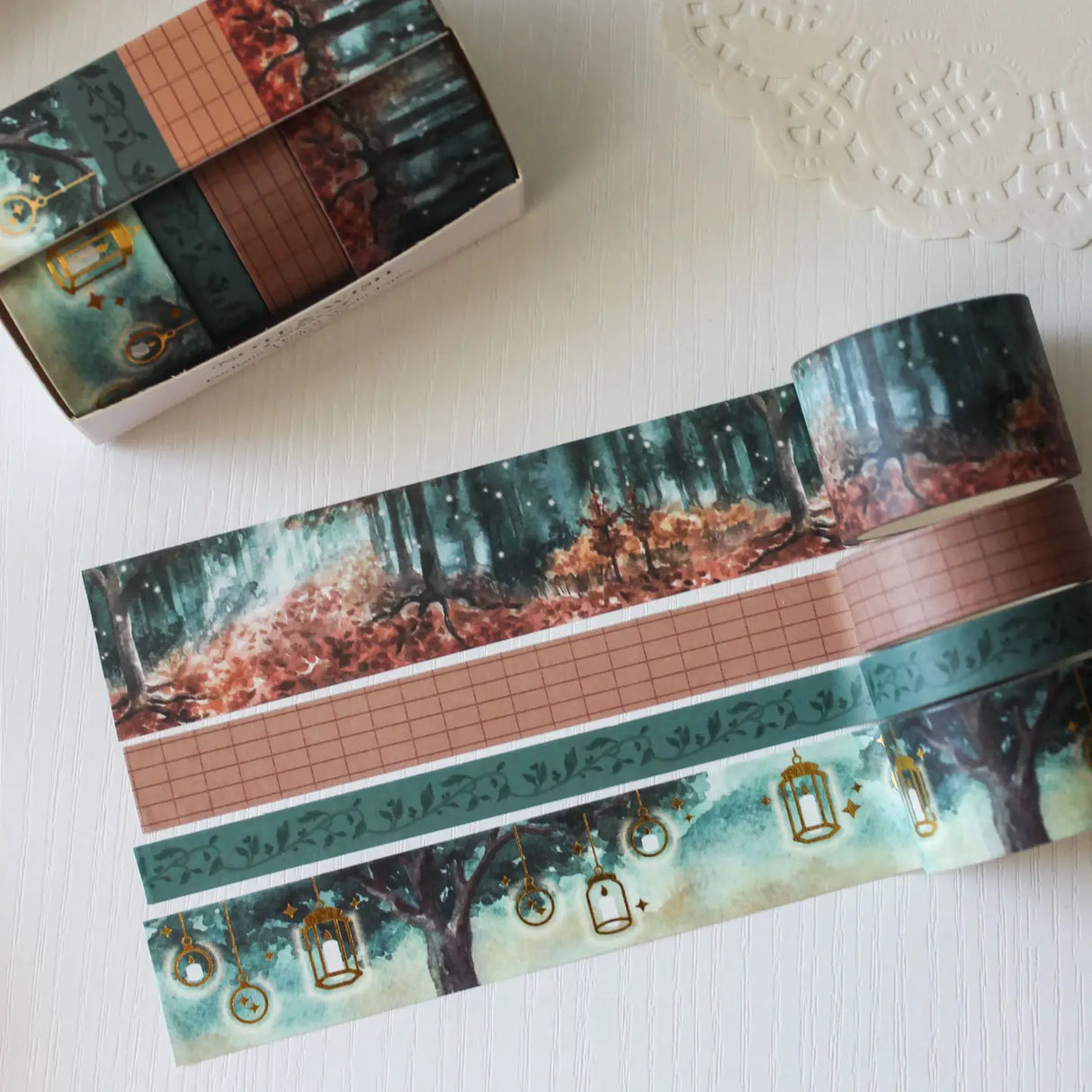 This enchanted forest washi tape gift set is designed for dreamers, storytellers, and stationery lovers who enjoy woodland walks at dusk. Featuring hand-painted watercolour forest scenes by Rebecca. Perfect for journaling and anyone who loves bringing the beauty of the British countryside into their creative projects.
30mm x 5m - Forrest
25mm x 5m with gold foil - Lanterns
5mm x 5m - Foliage
10mm x 5m - grid